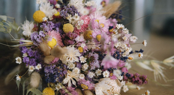 A lovely floral bouquet of flowers, consisting of violet, purple, and yellow colored flowers.